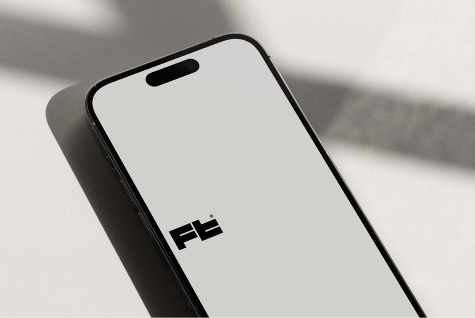 Device mockup from elevated angle casting dramatic natural light shadows
